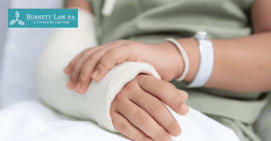 patient holding injured arm